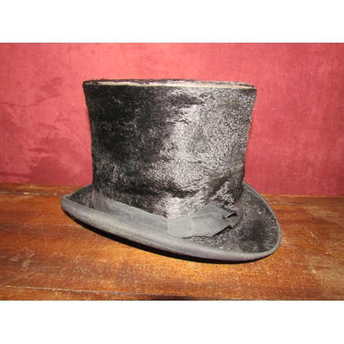 4193 - A vintage brown leather hat box with a top hat, a/f