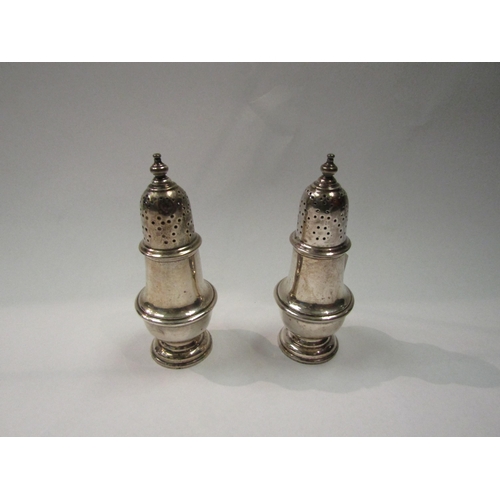 4309 - A pair of Adie and Lovekin Ltd silver pepperettes, each measuring 12cm high, weighted bases, 155g