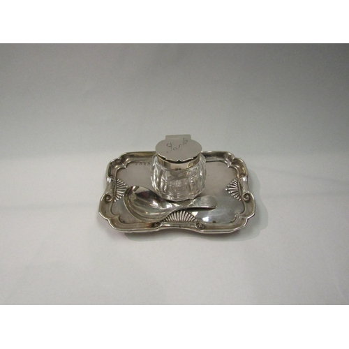 4310 - A silver and glass inkwell with lift-up bottle a/f and a silver caddy spoon