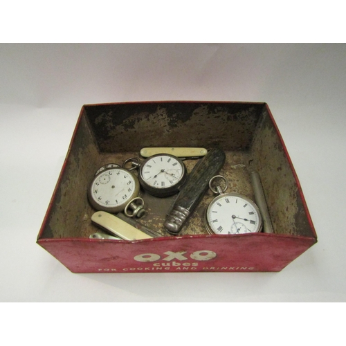 4318 - A vintage Oxo Cubes tin containing various pocket watches and penknives, etc