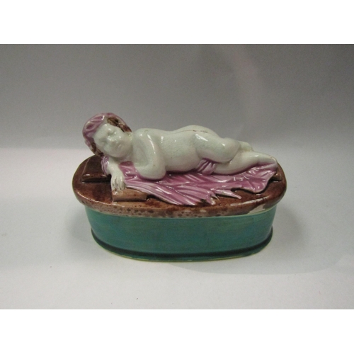 4324 - A Victorian majolica pin box with cherub design, 14cm long a/f   (R) £35