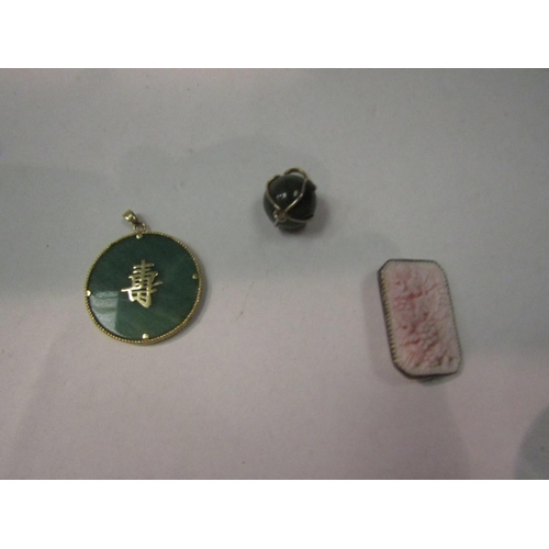 4365 - A circular jade pendant with 14k gold mount, a jade ball pendant and pink coral brooch