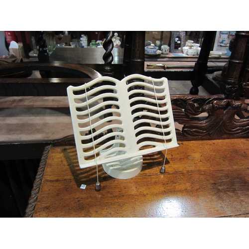 4201 - A Victor London cast metal cookery book stand in cream, 24cm tall