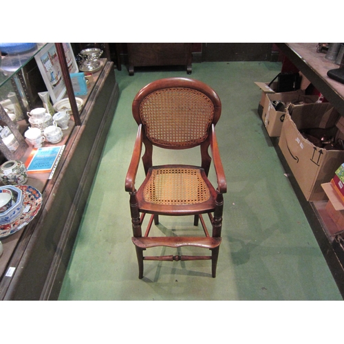 4210 - A Victorian child's high chair with cane seat and backrest on turned outswept fore legs