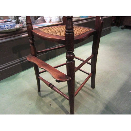 4210 - A Victorian child's high chair with cane seat and backrest on turned outswept fore legs