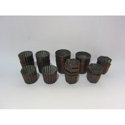 4224 - Nineteen copper tin canele molds