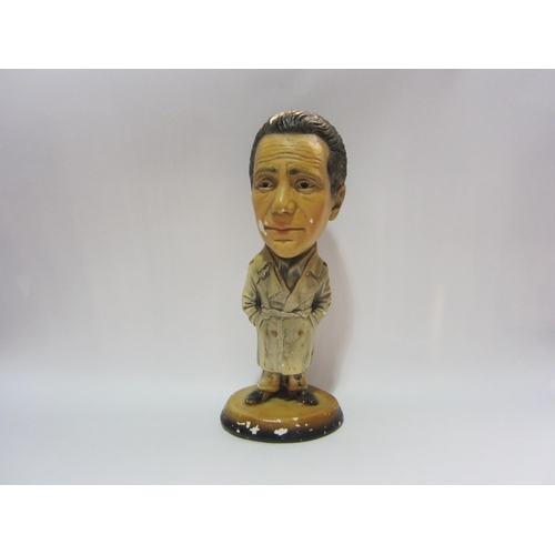 4280 - A vintage chalk figure depicting a gent in a rain mac, 40cm tall