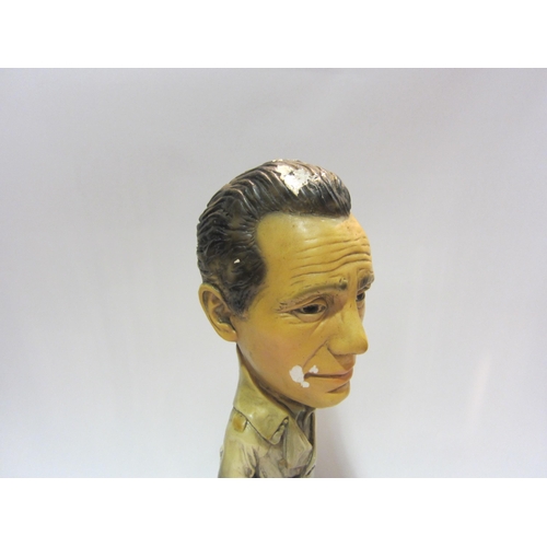 4280 - A vintage chalk figure depicting a gent in a rain mac, 40cm tall