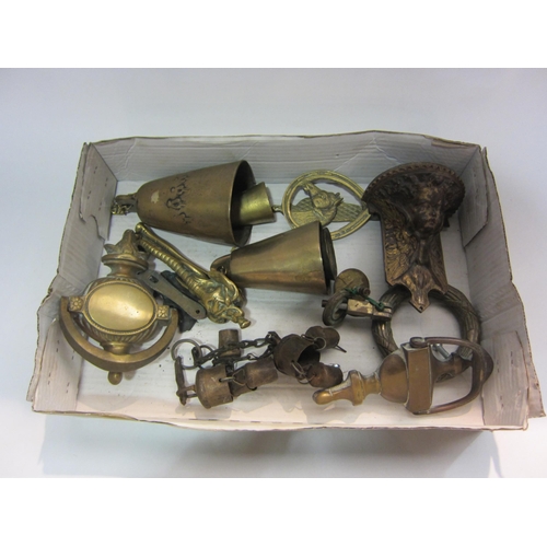 4302 - A box containing various brass door knockers and bells including elephant's head form and horseshoe ... 