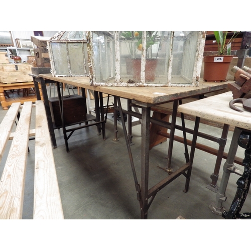 2055 - A pine trestle table on metal legs 136 x 65cm