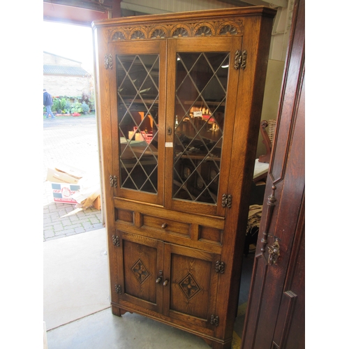 2457 - An Old Charm style oak full height corner cabinet, lead glazed top over drawer and cabinet base