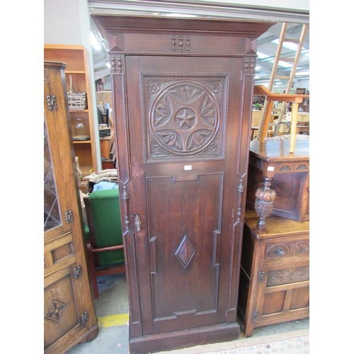 2458 - A Gothic revival oak slim wardrobe, star form carved panel, geometric mounts