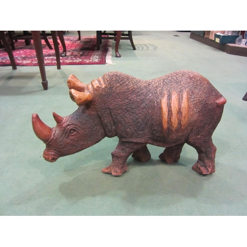 4010 - A hardwood carved figure of rhinoceros form, 35cm tall x 60cm long