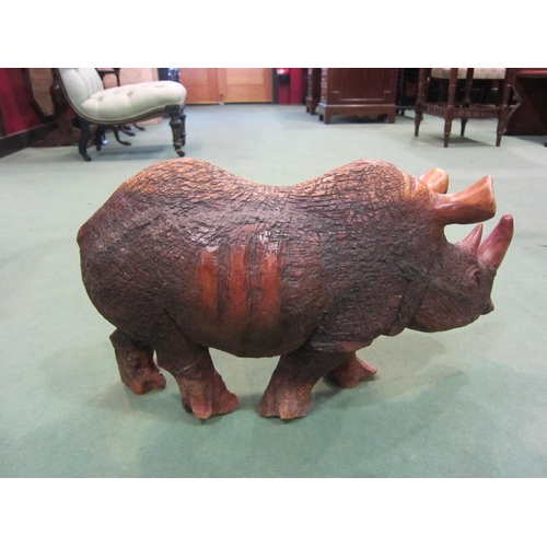 4010 - A hardwood carved figure of rhinoceros form, 35cm tall x 60cm long