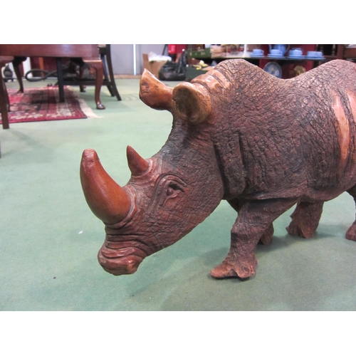 4010 - A hardwood carved figure of rhinoceros form, 35cm tall x 60cm long