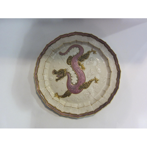 4013 - A Belleek dragon design charger with gilt detailing, staple repaired, 38cm diameter