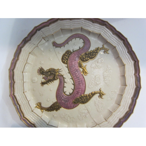 4013 - A Belleek dragon design charger with gilt detailing, staple repaired, 38cm diameter