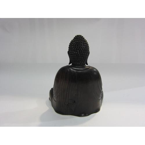 4014 - A carved wooden figure of seated Buddha, 20cm tall