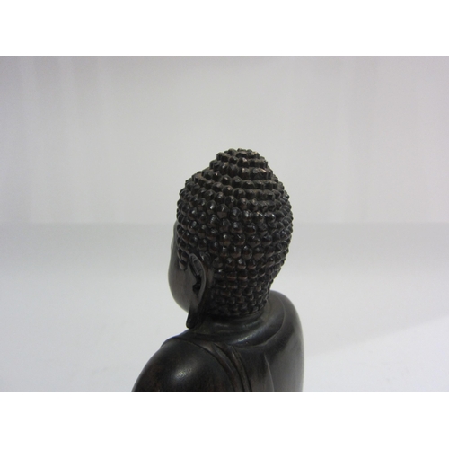 4014 - A carved wooden figure of seated Buddha, 20cm tall