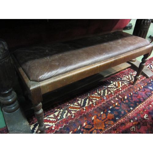 4169 - An oak piano stool with rexine type upholstery, 45cm tall x 100cm long x 37cm wide