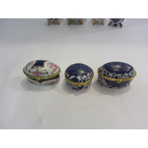 4438 - A small collection of four porcelain eggs on tripod legs, one containing a scent bottle, together wi... 