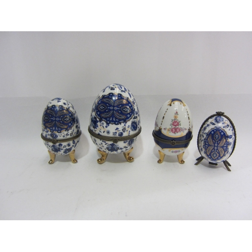 4438 - A small collection of four porcelain eggs on tripod legs, one containing a scent bottle, together wi... 