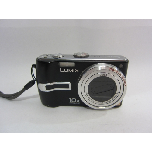 4449 - A Panasonic Lumix DMC-TZ3 camera with charger and instruction booklet