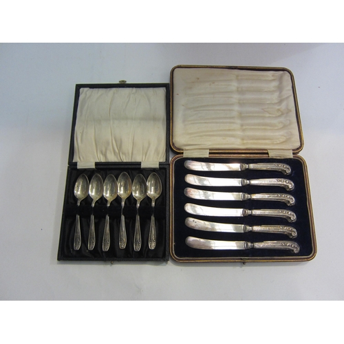 4453 - A set of silver handled butter knives with scroll handles together with a set of six silver teaspoon... 