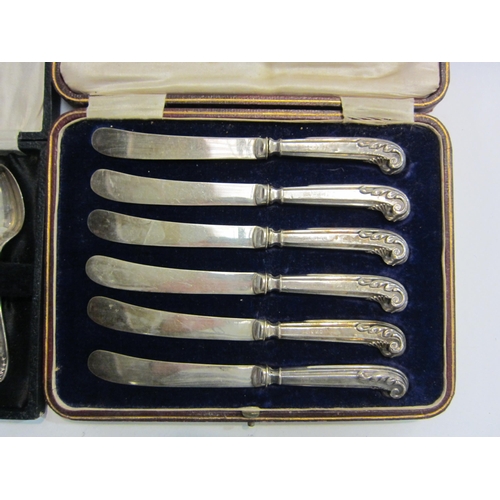 4453 - A set of silver handled butter knives with scroll handles together with a set of six silver teaspoon... 