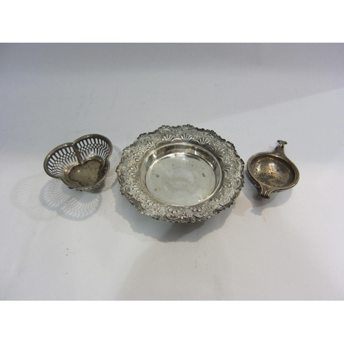 4459 - A silver foliate repousse dish, together with a tea strainer and a pierced bonbon dish raised on thr... 