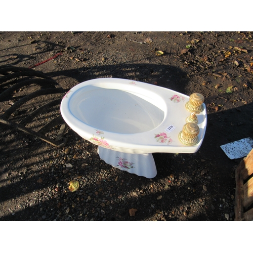 3229 - A white ceramic bidet with floral print pattern and gold plated taps