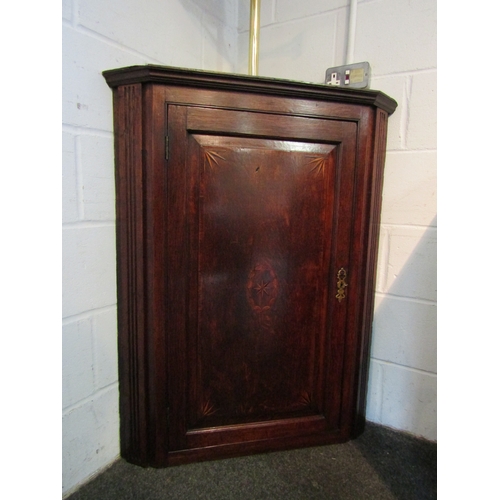 1043 - A George III inlaid oak single door corner cupboard with key, 107cm tall x 83cm wide x 46cm deep