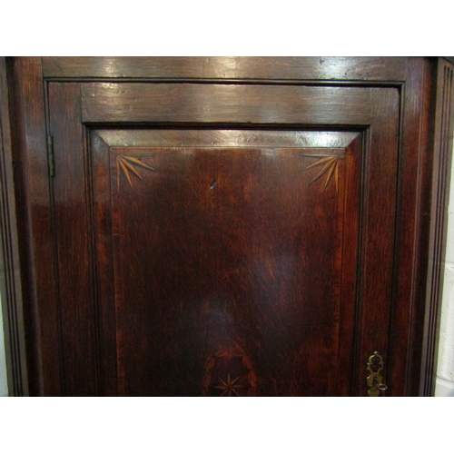 1043 - A George III inlaid oak single door corner cupboard with key, 107cm tall x 83cm wide x 46cm deep