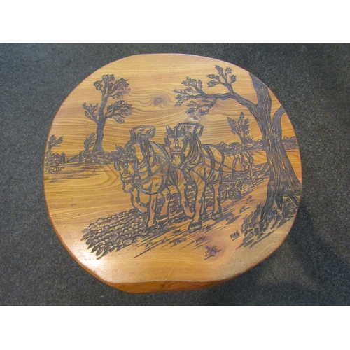 1159 - An elm occasional table with carved decoration of farmer and heavy horses ploughing a field, 37cm ta... 