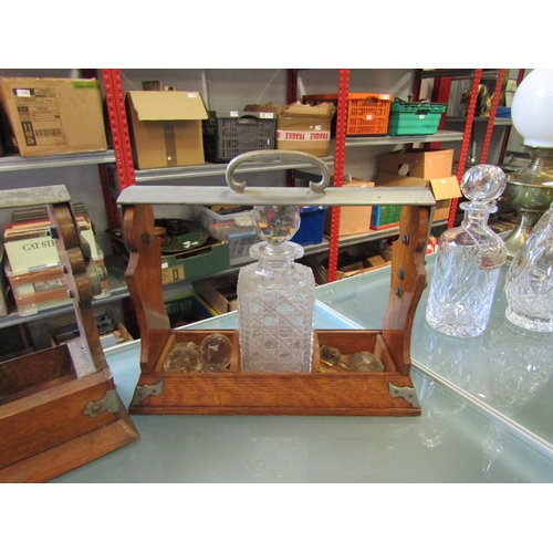 1247 - Three oak tantalus' with part crystal decanters and stoppers, one being Betjemanns Patent (incomplet... 