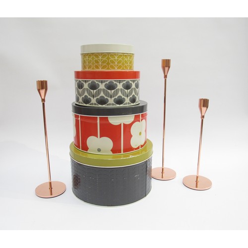 1339 - An Orla Kiely set of four metal storage tins and a contemporary trio of tapering form candlesticks i... 