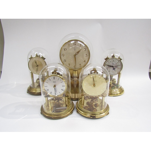 8021 - Five brass anniversary clocks under glass domes including Junghans ATO electric and Kundo examples, ... 