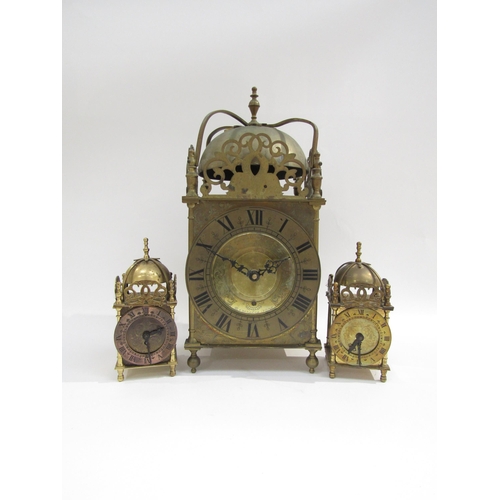 8032 - A large brass modern lantern clock with quartz movement and two smaller examples (3)