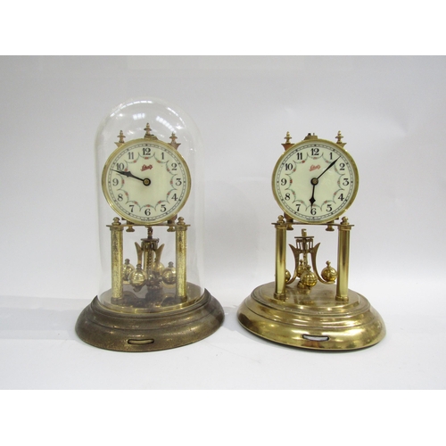 8038 - A pair of brass Schatz anniversary clocks, one under plastic dome. Both with white enamel dial with ... 