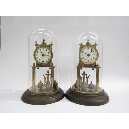 8039 - A near identical pair of brass anniversary clocks under glass and plastic domes. Both with white ena... 
