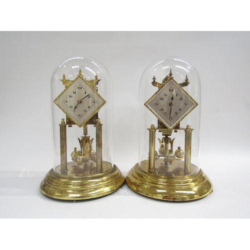 8040 - A near identical pair of brass anniversary clocks under glass dome, one marked Koma to back. Both wi... 