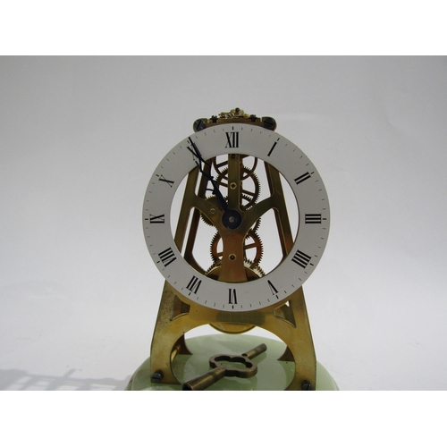 8057 - A small onyx base skeleton clock under glass dome, with Roman numeral dial and key, 18cm tall
