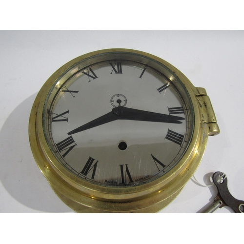 8064 - A brass bulkhead clock with Roman numerals and subsidiary seconds dial, made in Germany, with key. 1... 