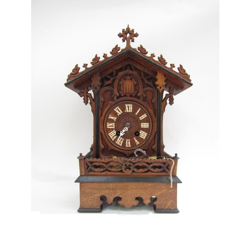 8066 - A Black Forest mantle cuckoo clock with key and pendulum, (a/f). 49cm tall    (SPECIAL)  (R)  £140