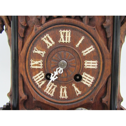 8066 - A Black Forest mantle cuckoo clock with key and pendulum, (a/f). 49cm tall    (SPECIAL)  (R)  £140