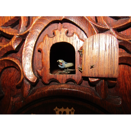 8066 - A Black Forest mantle cuckoo clock with key and pendulum, (a/f). 49cm tall    (SPECIAL)  (R)  £140