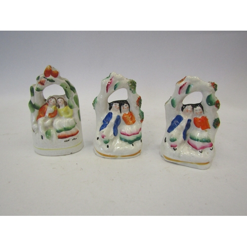 1465 - A group of three Victorian Staffordshire figures of lovers beneath arbours, approximately 10cm tall