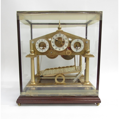 8077 - A Congreve Rolling Ball brass clock with our column frame and central zigzag track for the ball, an ... 