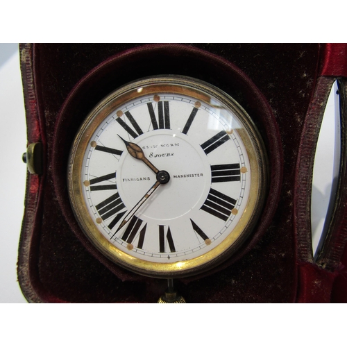 8115 - An embossed silver travelling clock case together with a Finnigans of Manchester 8 day clock