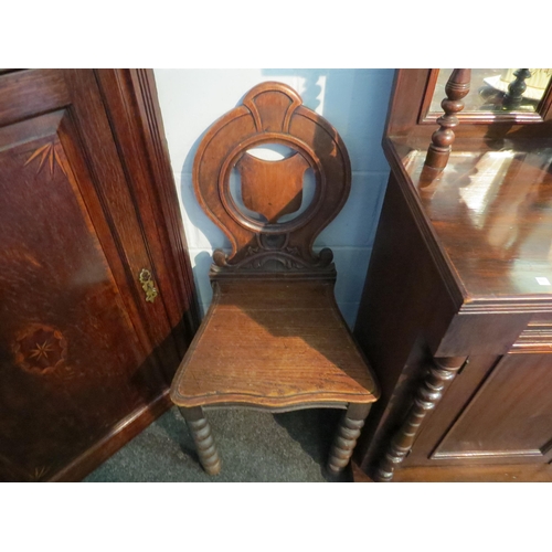 1038 - A pair of Victorian oak hall chairs, shield back, bobbin supports